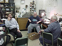 Photo. View of the archaeology
               lab with Paul Barans, Larry Morris and Elaine Dowd.