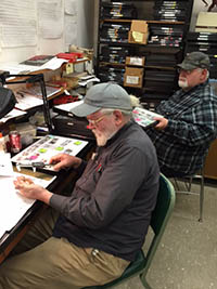 Photo. View of the archaeology
               lab with Garry Summers and Chuck Stephens.